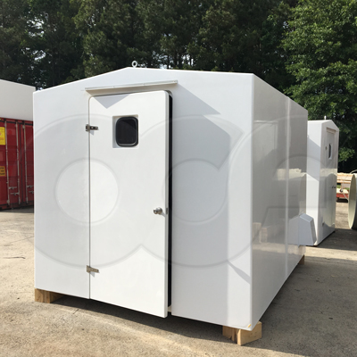 6 x 10 fiberglass equipment shelter manufactured by Openchannelflow with strap hinges mounting door