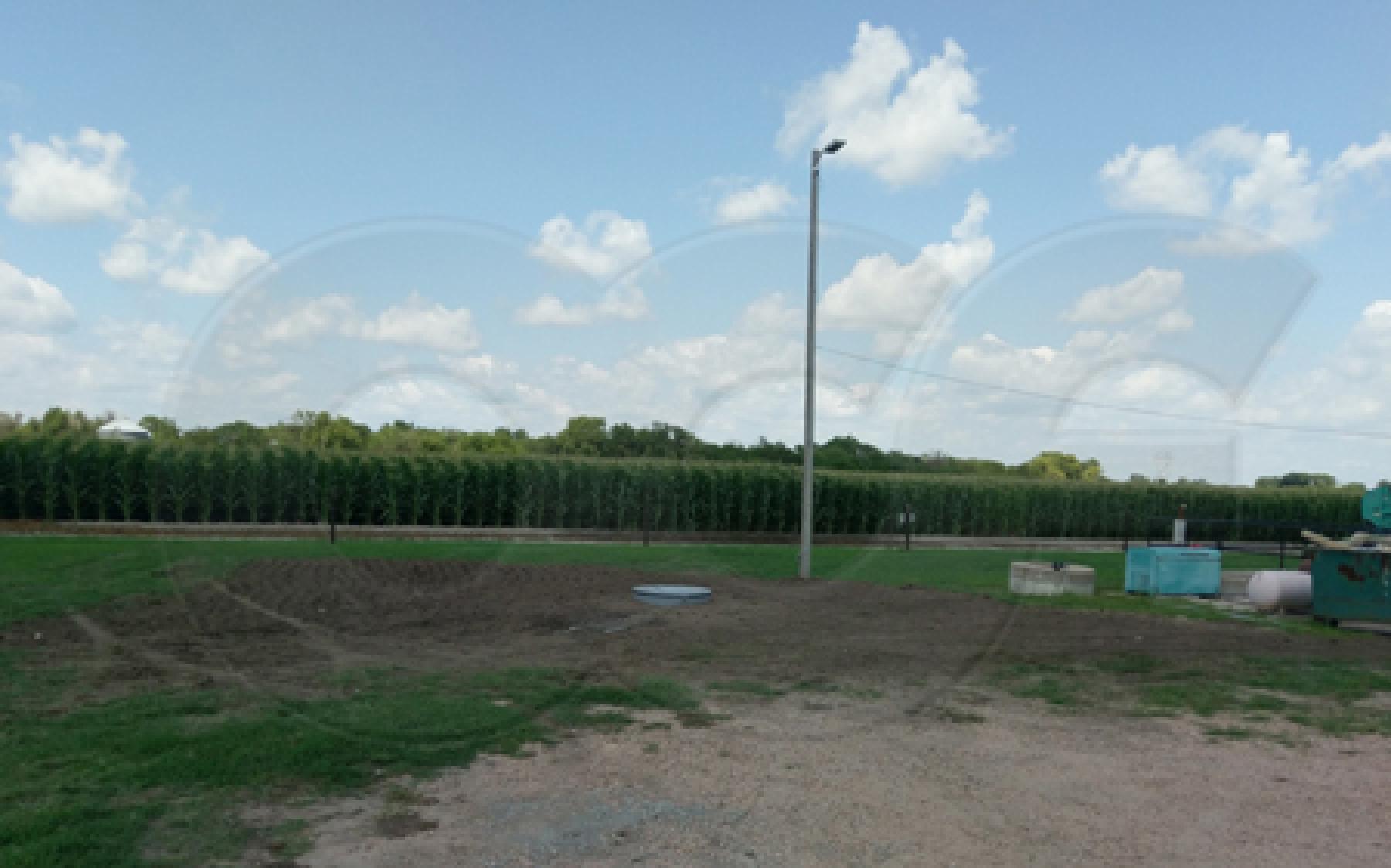 completed installation of a domed top fiberglass flow metering manhole