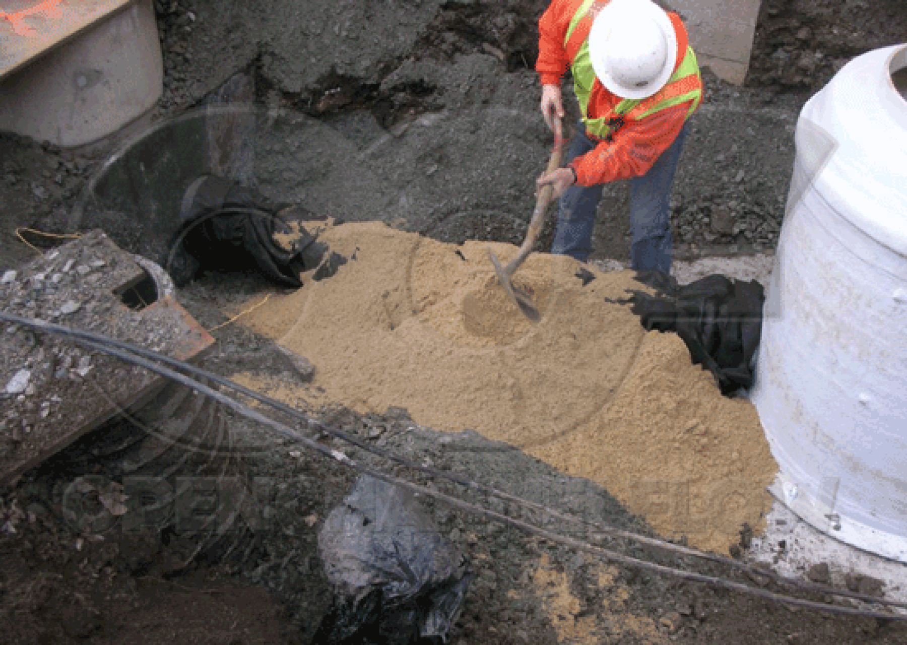 backfilling fiberglass Metering Manhole excavation under piping