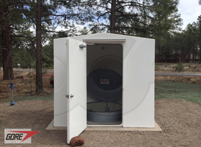 Fiberglass equipment shelter with a Packaged Metering Manhole installed inside