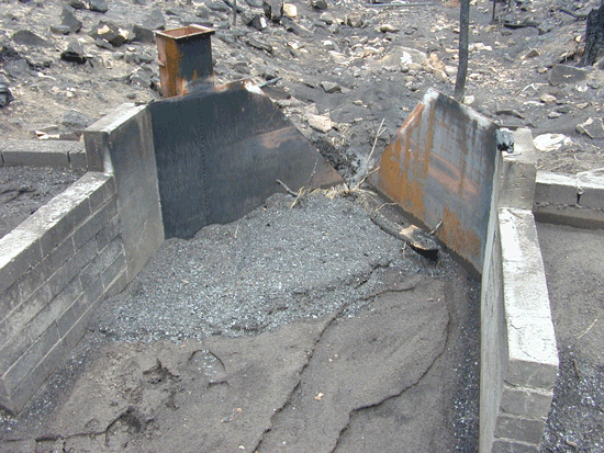 Steel H flume in need of maintenance and sediment cleaning after a fire