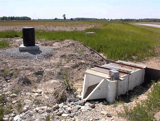 H flume measuring field / plot runoff with sediment on the floor of the flume and the approach section