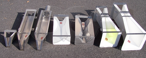 From left to right: stainless steel 0.4'-HS flume, stainless steel 0.4' HS-flume with approach section, stainless steel 0.4' HS-flume with approach section and inlet pipe stub, fiberglass Small 60 Degree Trapezoidal flume, stainless steel Small 60 Degree Trapezoidal flume, fiberglass 1-inch Parshall Flume, and fiberglass 2-inch Parshall flume