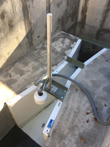 ultrasonic transducer mounted over a Parshall flume measuring treated WWTP discharge
